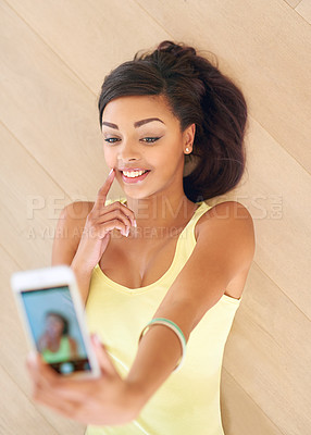 Buy stock photo Above, lying on floor and taking selfie for teenage girl with smile for social media post on holiday break for online memories. Young person or generation z and playful with mobile for photo capture