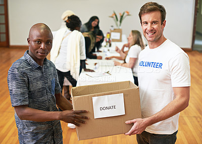 Buy stock photo Cropped portrait of two volunteers carrying a donations box