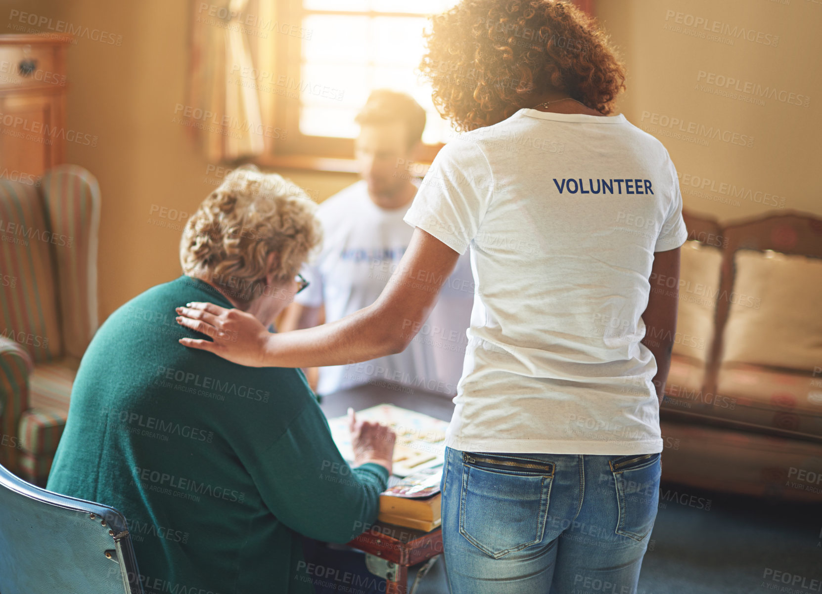 Buy stock photo Shot of volunteers working with seniors at a retirement home