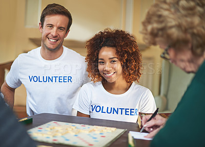 Buy stock photo Volunteers, happy and portrait with senior people in retirement home, board game and social interaction for advocacy. Man, woman and elderly women with scrabble for volunteering and community service