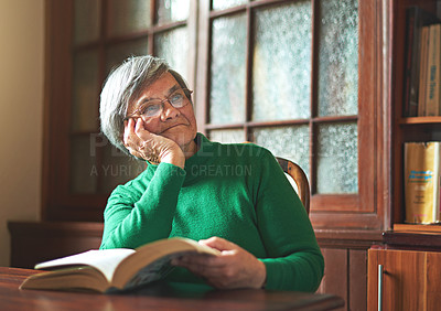 Buy stock photo Shot of a smiling senior woman reading