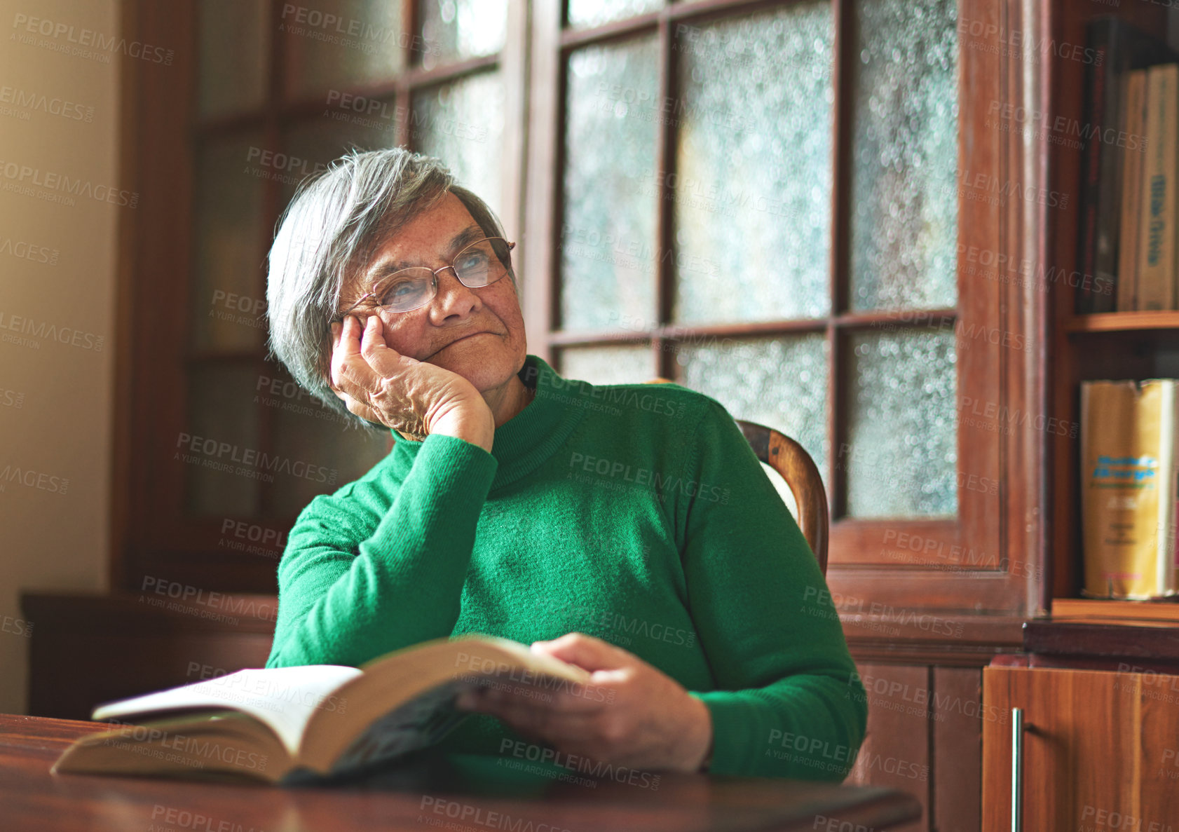 Buy stock photo Shot of a smiling senior woman reading