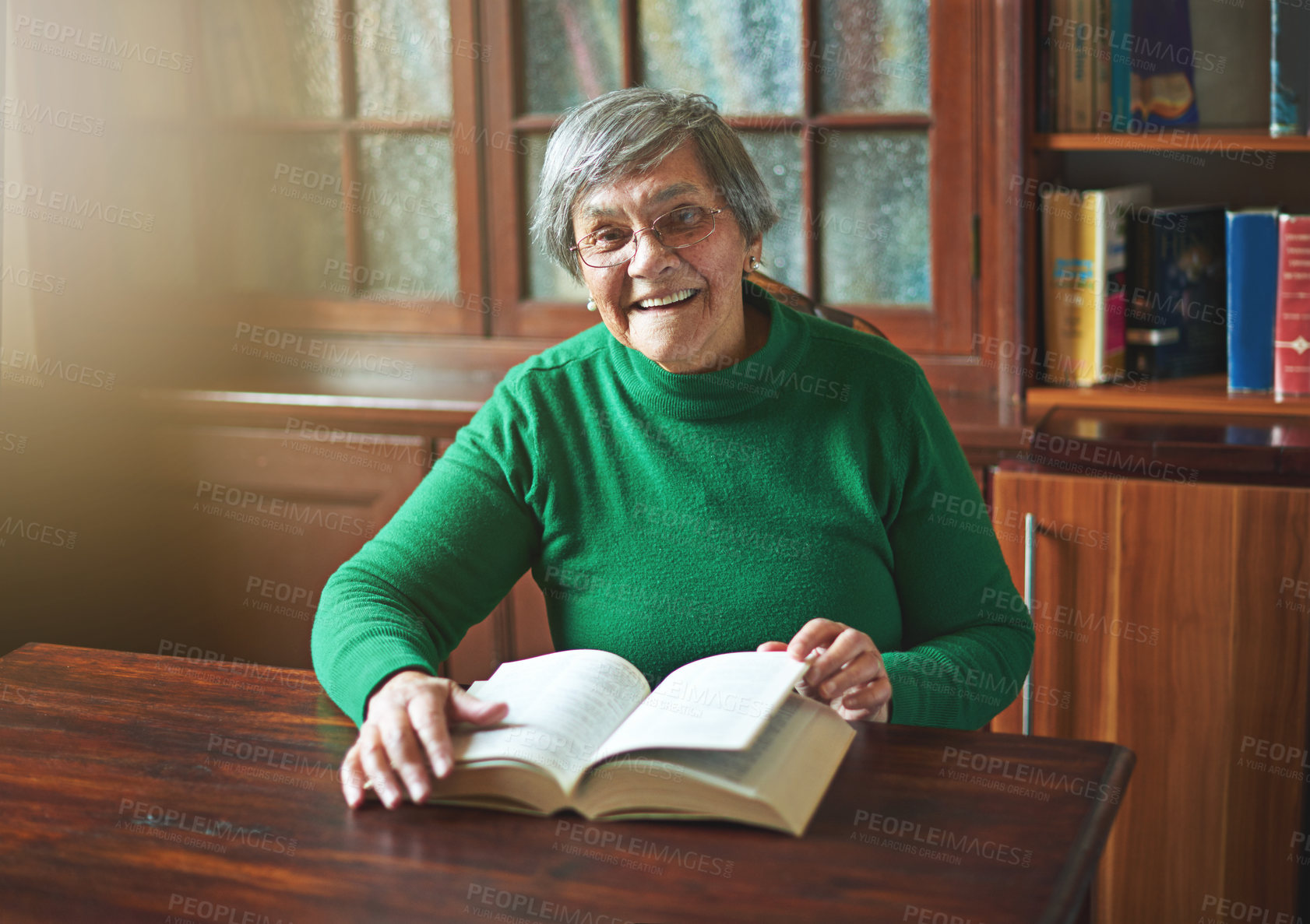 Buy stock photo Portrait of a smiling senior woman reading
