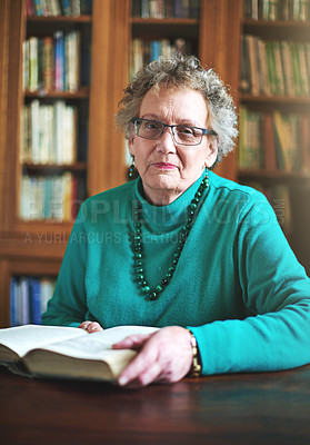 Buy stock photo Portrait of a senior woman sitting at a table reading