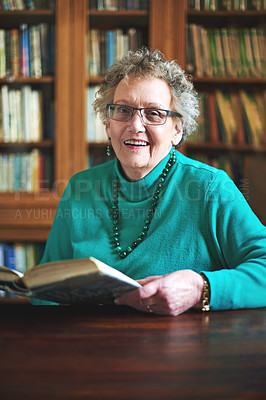 Buy stock photo Senior woman, portrait and reading book in library, literature and fiction novel in retirement. Female person, reader hobby and confident for language study, knowledge and information or happy story