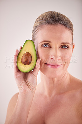 Buy stock photo Beauty, avocado and portrait of mature woman in studio for health, wellness or natural face routine. Smile, skincare and female person with organic fruit for dermatology treatment by white background