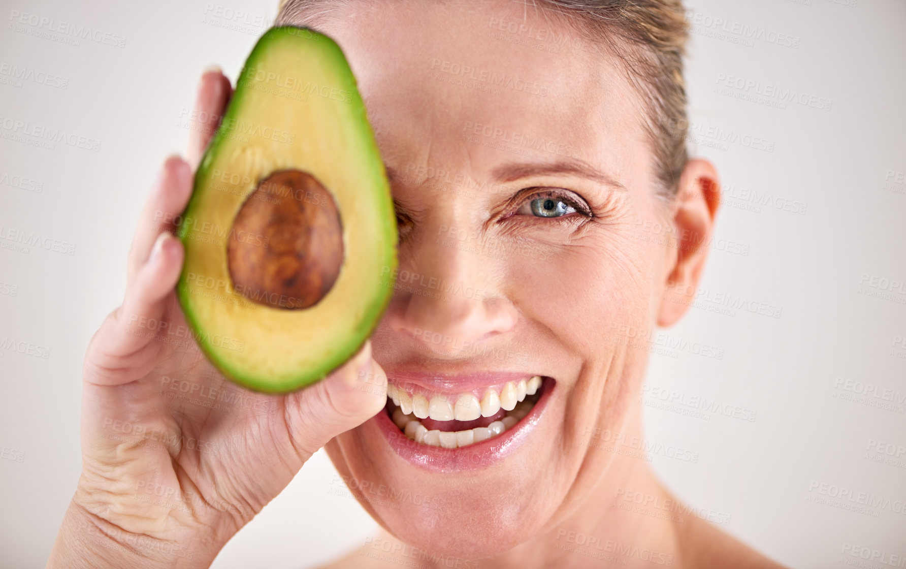 Buy stock photo Happy, avocado and portrait of woman with skincare in studio for health, wellness or natural routine. Smile, beauty and mature person with organic fruit for dermatology treatment by white background.