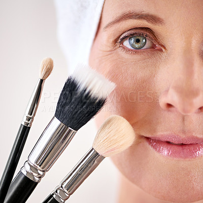 Buy stock photo Portrait, woman and makeup with brushes, closeup and beauty treatment on white studio background. Face, person and model with product and tool with wellness and skincare with cosmetic and dermatology