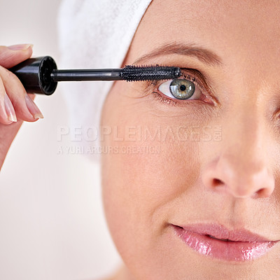 Buy stock photo Makeup, mascara or portrait of woman with brush in studio for beauty, cosmetics or application. Eyelash, white background or face of mature model with product or tool for volume, glamour or aesthetic