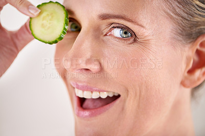 Buy stock photo Skincare, cucumber and portrait of mature woman in studio for health, wellness or natural routine. Smile, beauty and female person with organic vegetable for dermatology treatment by gray background.