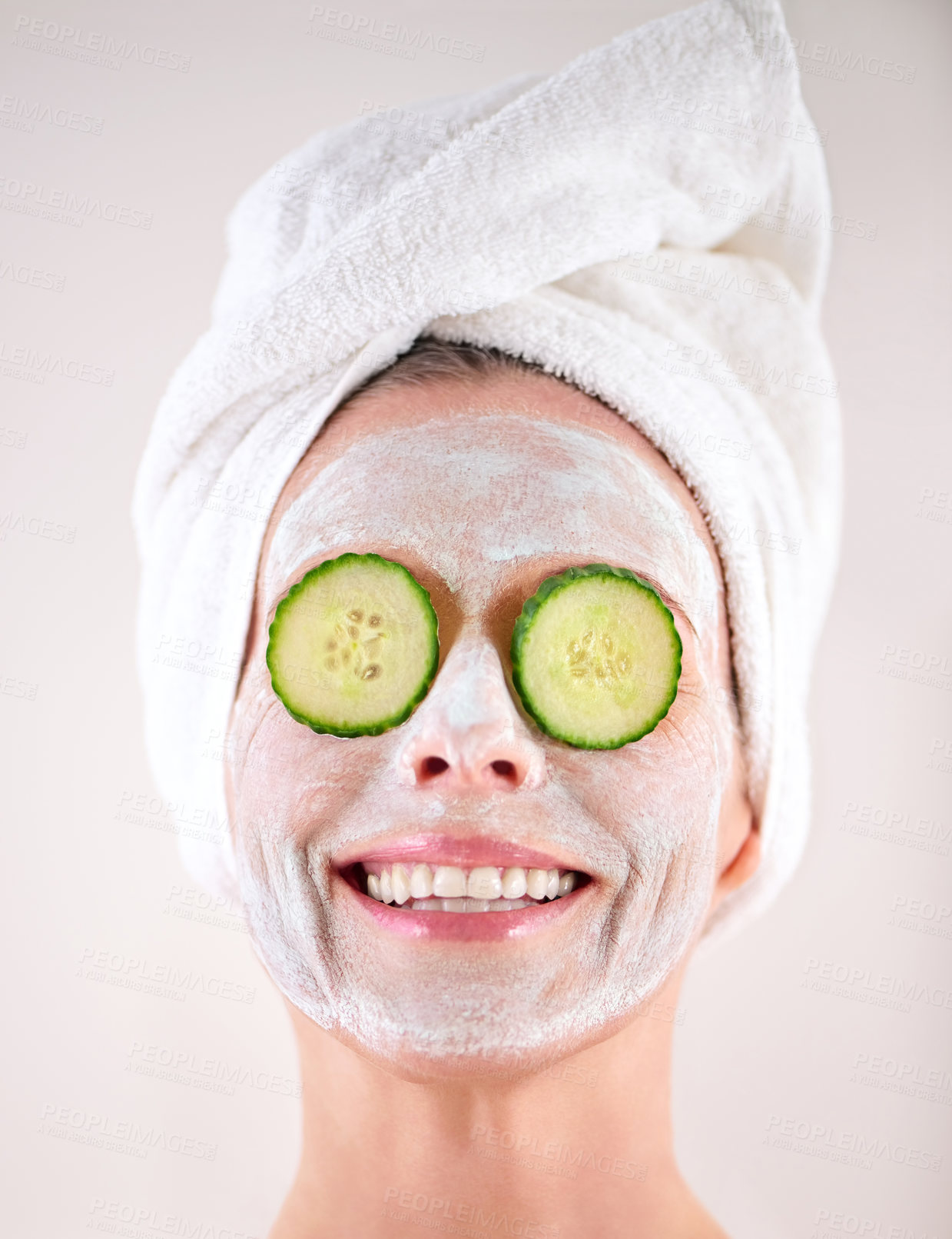 Buy stock photo Spa, mask or woman with cucumber facial, skincare in studio with natural detox, smile or cosmetics. Happy model, confidence or face with lotion for anti aging treatment or beauty on white background