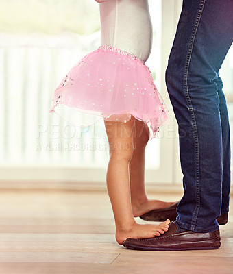 Buy stock photo Legs, feet with father and child dancing, teaching and learn with music and rhythm at family home. Man, young girl and standing together with activity for bonding, ballet with safety and support