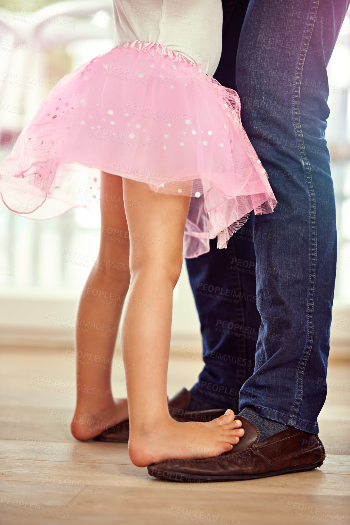 Buy stock photo Legs, feet with father and daughter dance, teaching and learn with music and rhythm at family home. Man, young girl and standing together with activity for bonding, ballet with safety and support