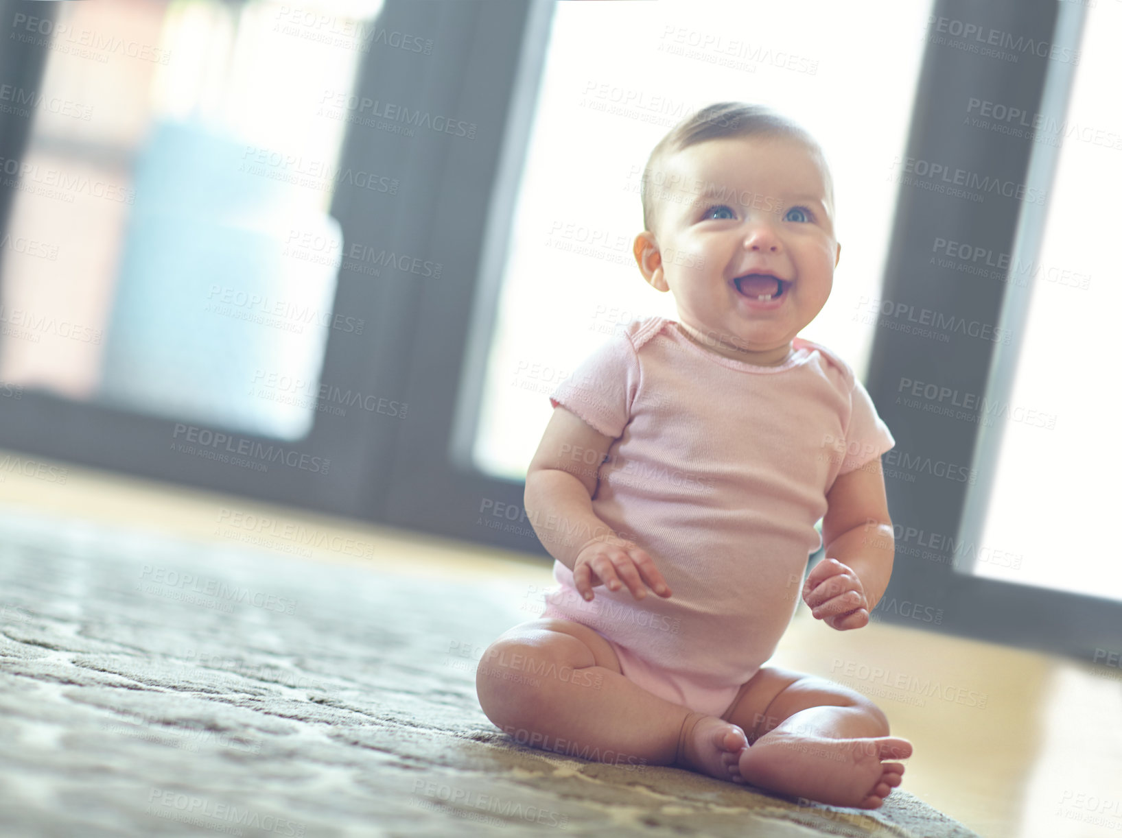 Buy stock photo Happy, cute and adorable baby girl in her home with a smile sitting and playing on the floor. Happiness, child development and excited beautiful infant child learning to crawl in a room at the house.
