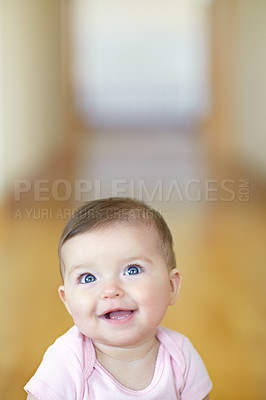 Buy stock photo Baby, mockup and growth with an adorable girl child looking curious in her home alone for development. Face, smile or mock up and a cute female infant with blue eyes in a house feeling happy