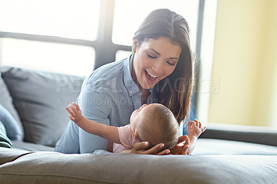 Buy stock photo Shot of a mother with her baby girl on the sofa at home