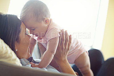 Buy stock photo Mom, bonding or forehead touch with baby girl on house living room, relax nursery or family home sofa in trust or love. Smile, happy or infant child playing mother in support, security or relax game