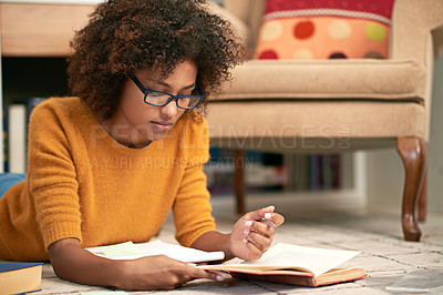 Buy stock photo African woman, books and reading on floor in library for  learning, relax and study for education. Female student, novel and concentrate with glasses for literature, homework or exam indoor      