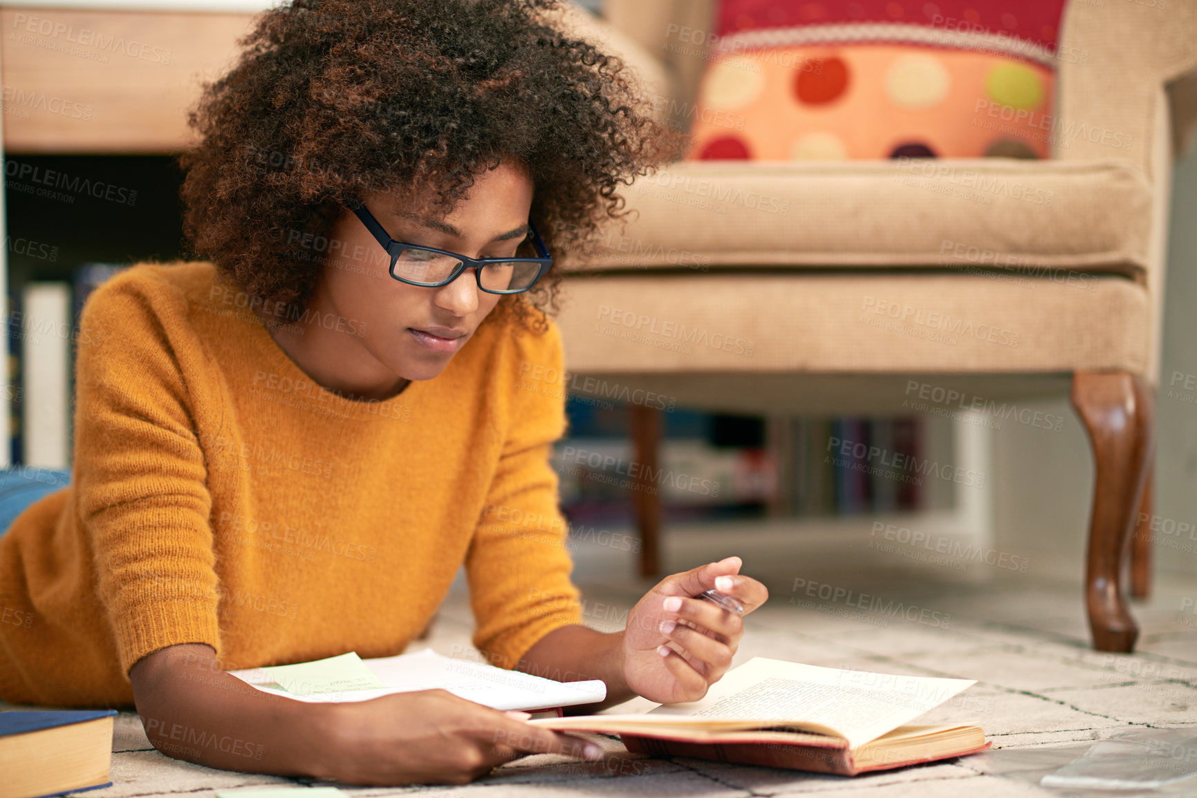 Buy stock photo African woman, books and reading on floor in library for  learning, relax and study for education. Female student, novel and concentrate with glasses for literature, homework or exam indoor      