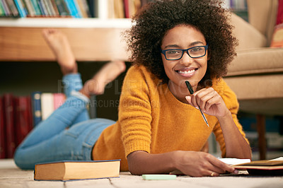 Buy stock photo Full length portrait of a young woman lying on the floor while studying