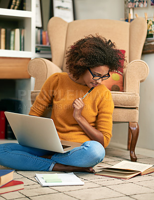 Buy stock photo Laptop, library and thinking woman on floor, book and study for education. Internet, learning and eyewear for female African student with afro, assignment or technology for knowledge and reading