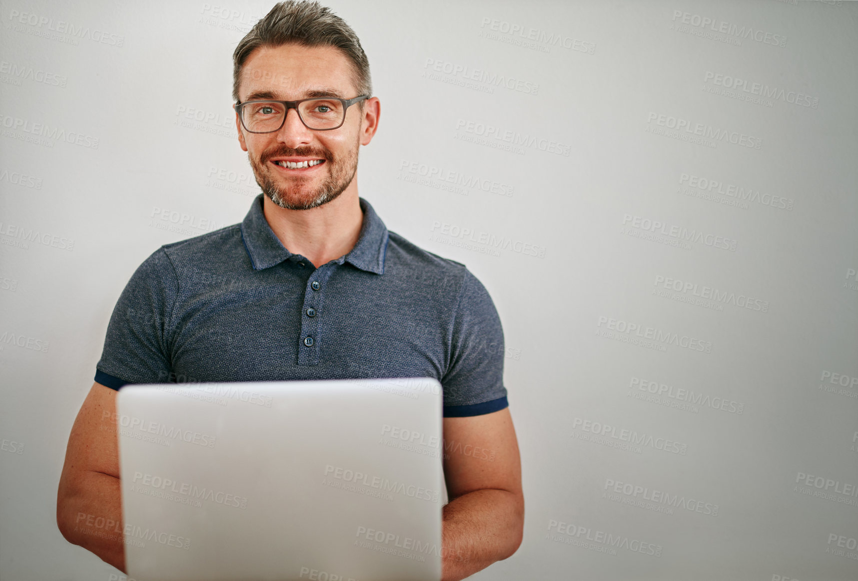 Buy stock photo Businessman, portrait  and happy in studio with laptop, relax and confidence of employee or staff. Creative, designer and male person, startup and worker with pride, company and model in job
