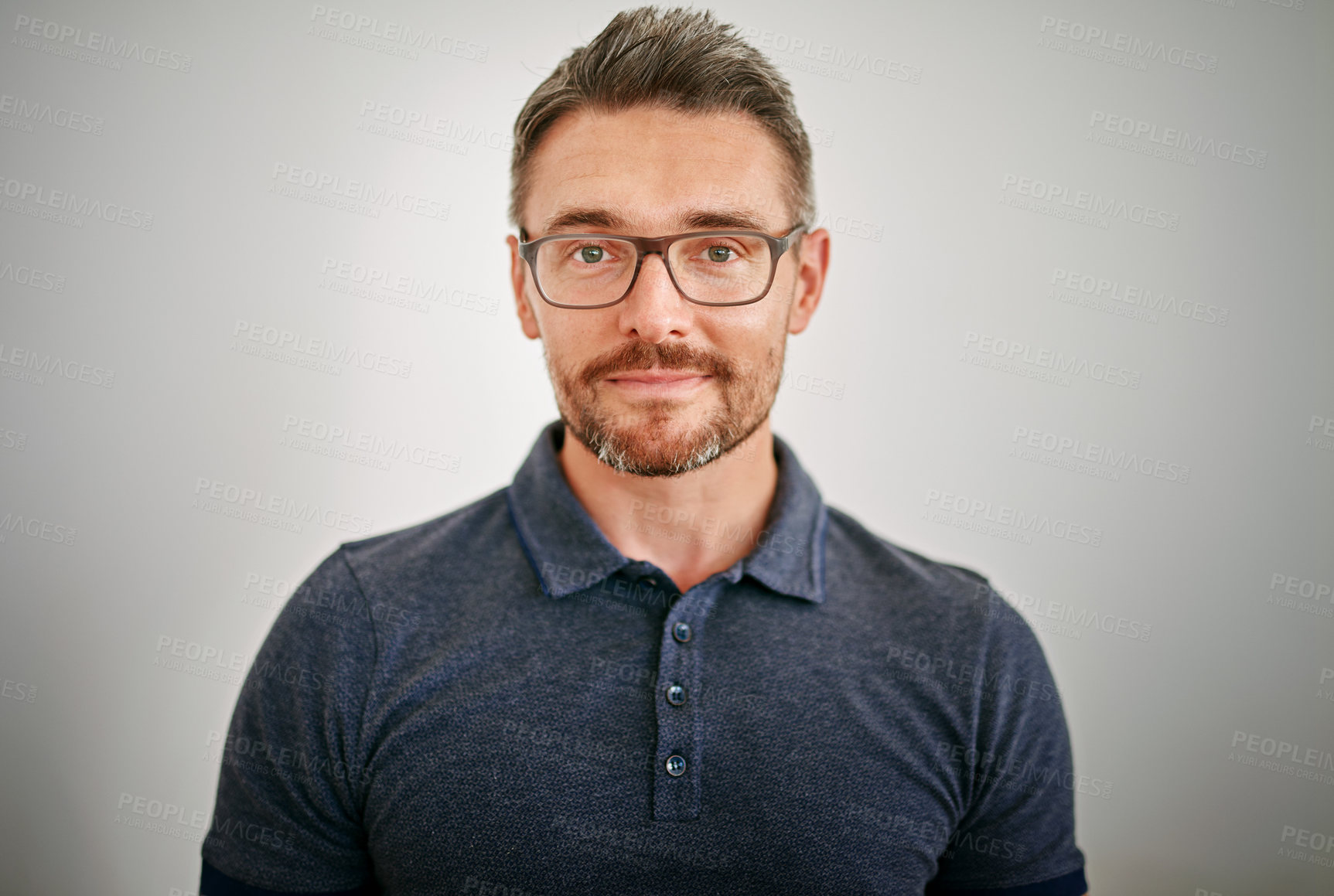 Buy stock photo Cropped portrait of a mature man standing against a gray background