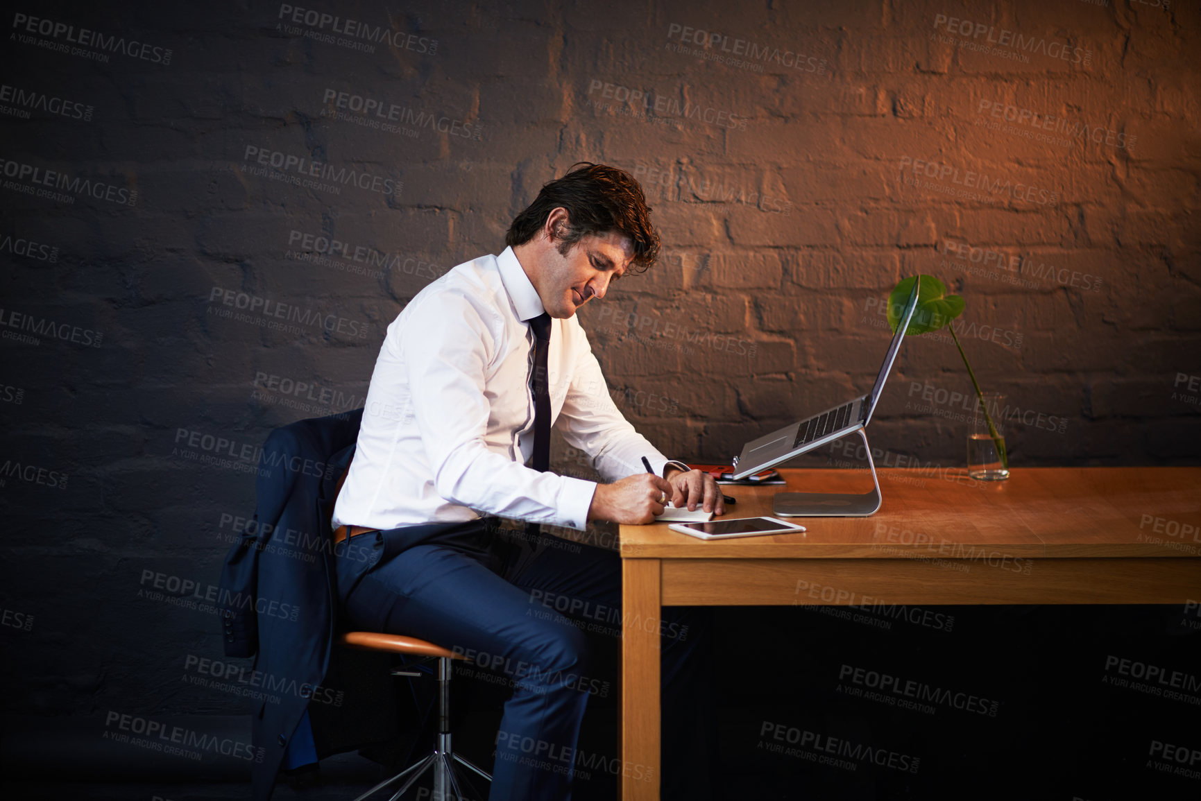 Buy stock photo Shot of a businessman working late at the office