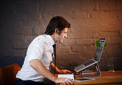 Buy stock photo Shot of a businessman working late at the office