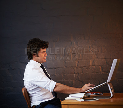 Buy stock photo Shot of a businessman working late at the office