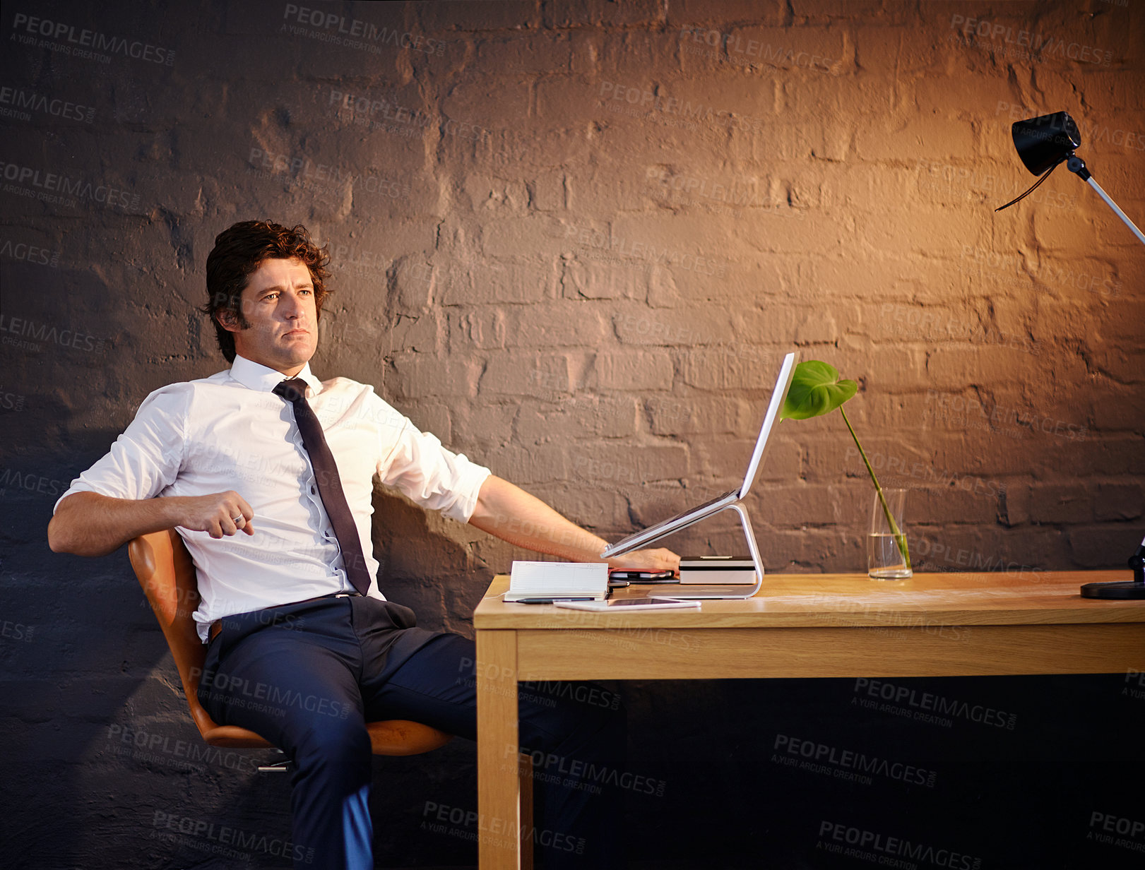 Buy stock photo Shot of a businessman working late at the office