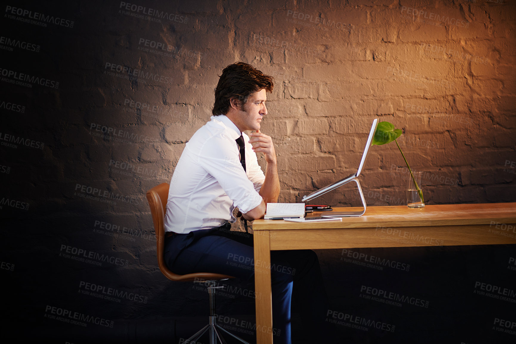 Buy stock photo Shot of a businessman working late at the office