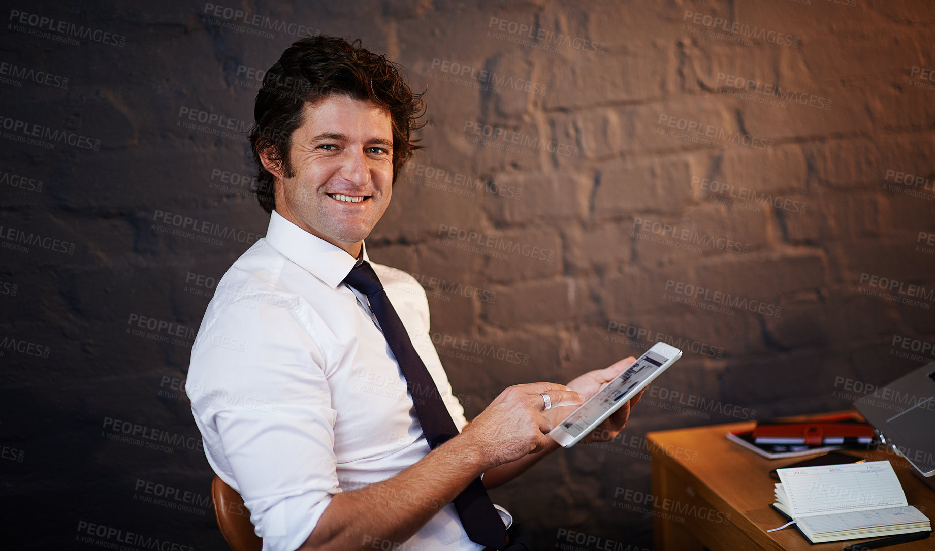 Buy stock photo Shot of a businessman using a digital tablet in the office