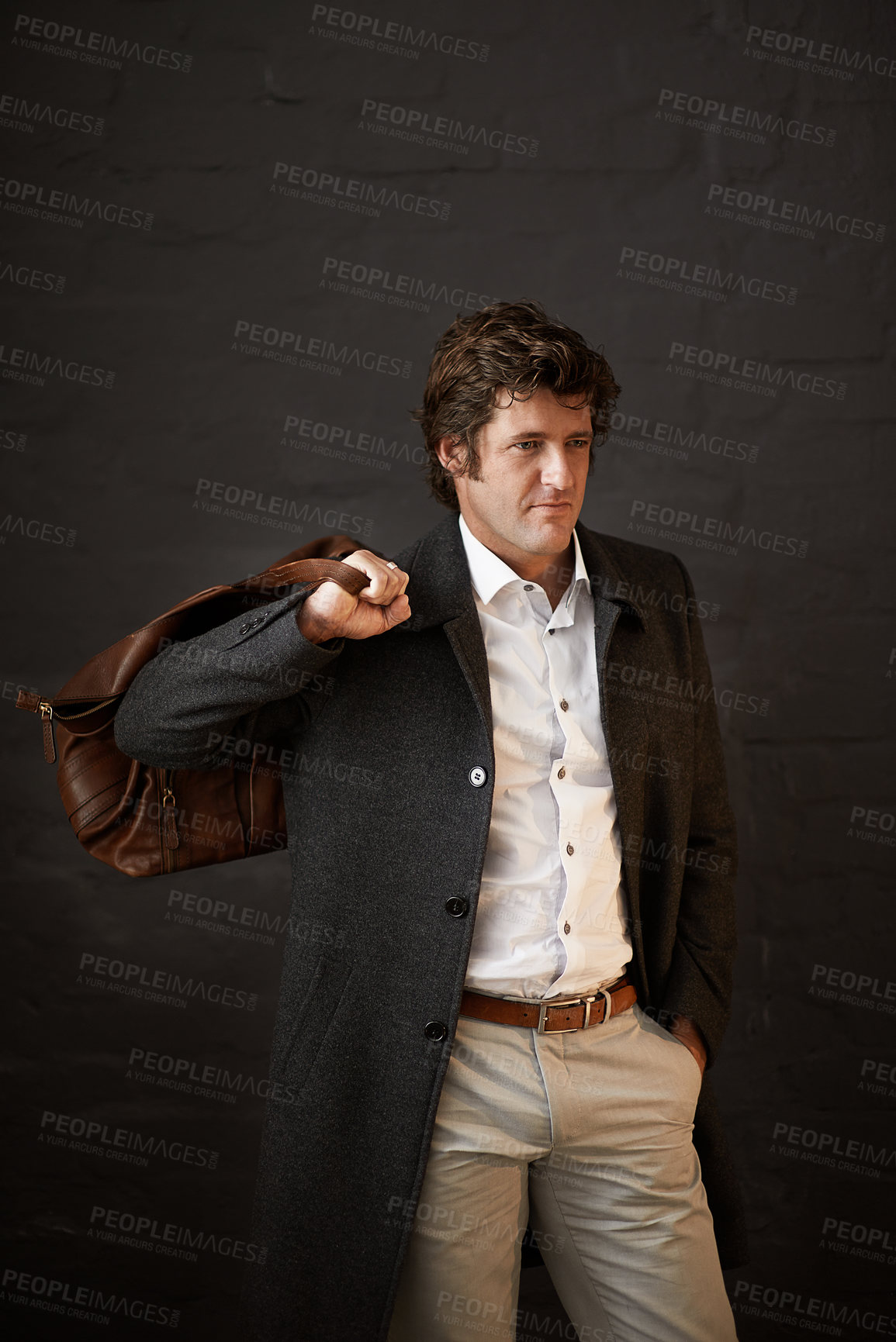 Buy stock photo Thinking, fashion and business man with leather bag for planning or decision on brick wall background. Style, clothes or professional entrepreneur with vision, dream or idea for travel with salesman