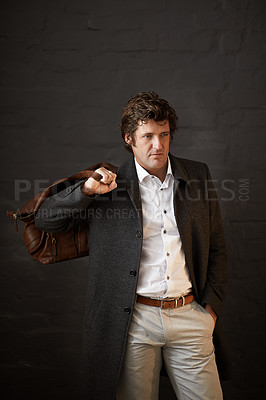 Buy stock photo Thinking, style and business man with leather bag for planning or decision on brick wall background. Fashion, luggage and professional entrepreneur with vision, dream or idea for travel with salesman