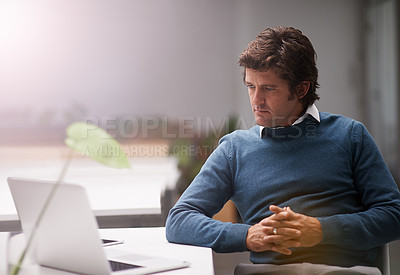 Buy stock photo Cropped shot of a businessman working on a laptop in an office