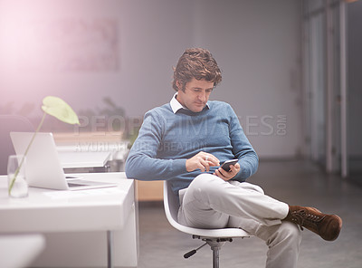 Buy stock photo Cropped shot of a businessman using a phone in the office