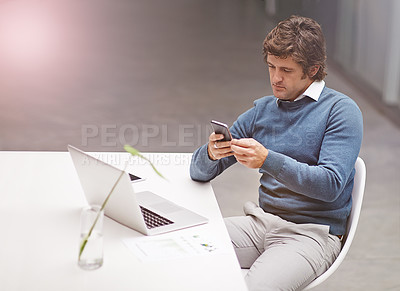 Buy stock photo Cropped shot of a businessman using a phone in the office
