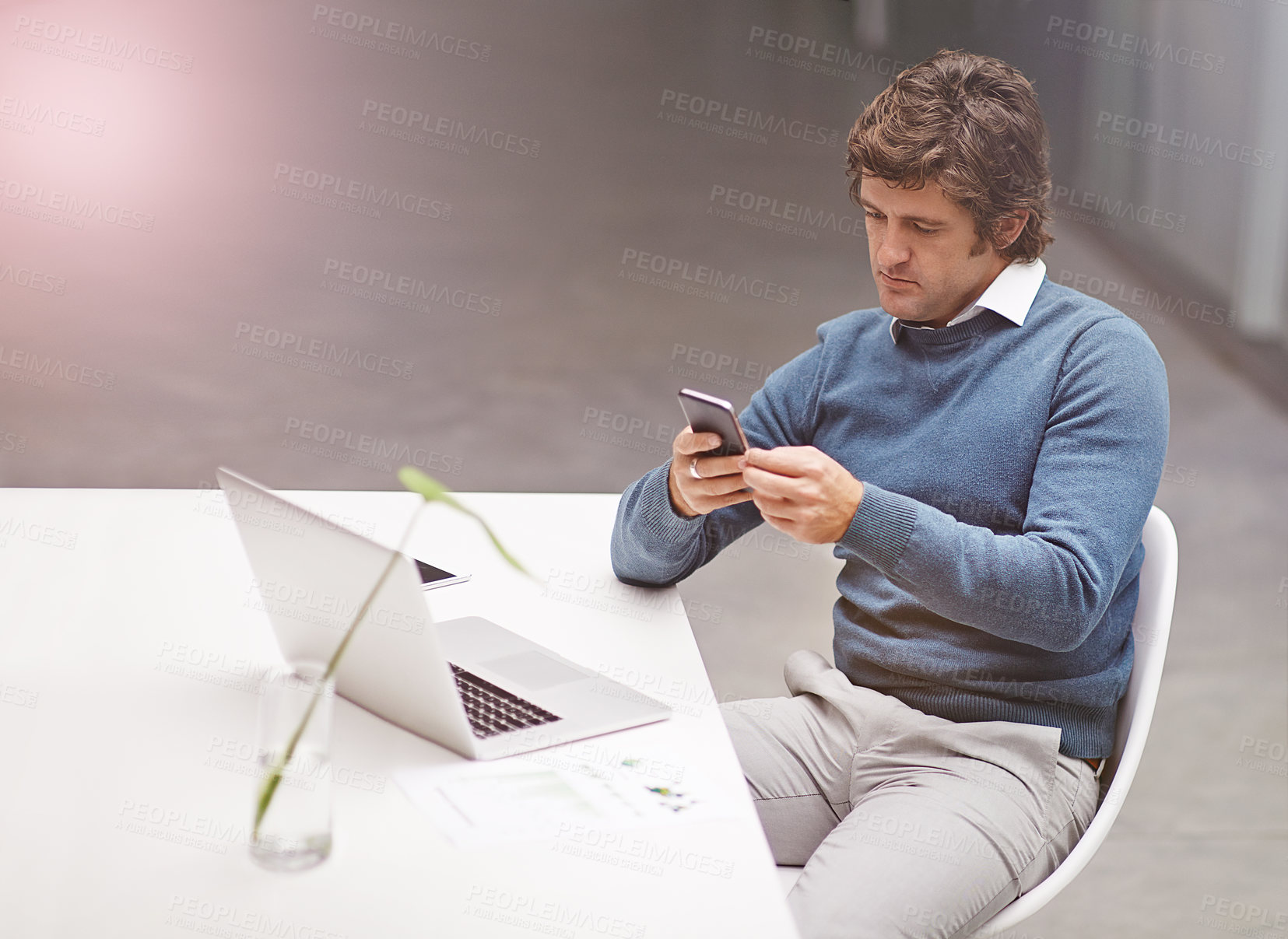 Buy stock photo Cropped shot of a businessman using a phone in the office