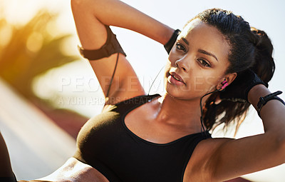 Buy stock photo Shot of a young woman doing sit ups