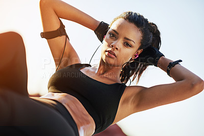 Buy stock photo Shot of a young woman doing sit ups