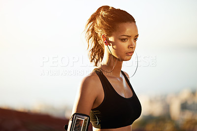 Buy stock photo Shot of a young woman taking a break from her workout