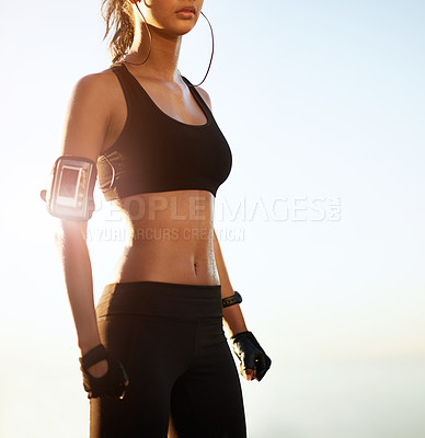 Buy stock photo Cropped shot of a young woman taking a break from her workout