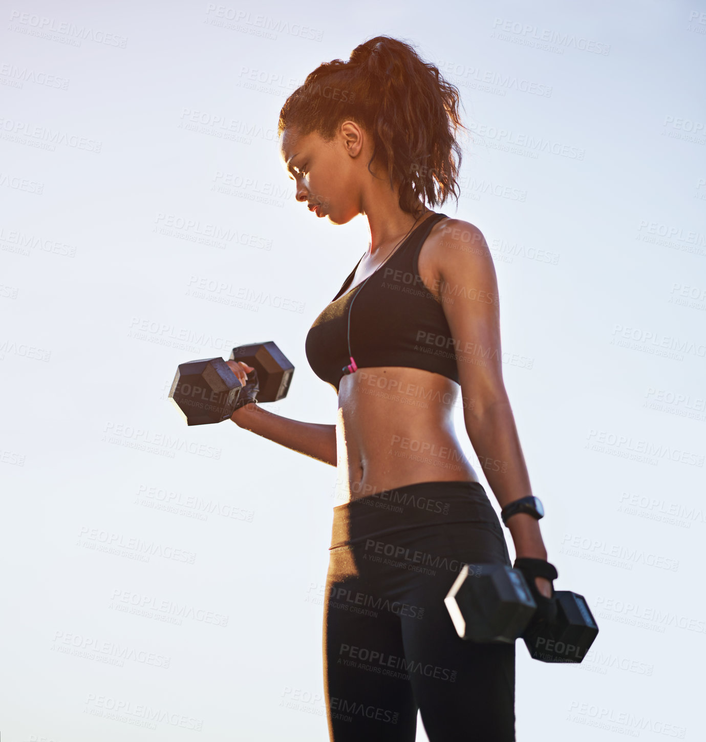 Buy stock photo Black girl, blue sky and dumbbells for power training, outdoor and bodybuilder for weightlifting. Female person, equipment and strong athlete to exercise, fitness and biceps for muscle development