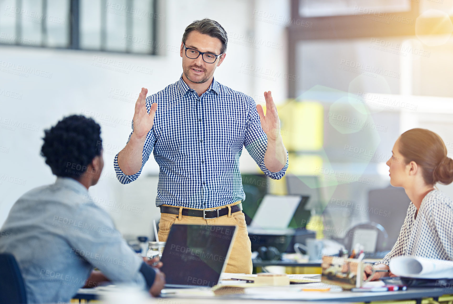 Buy stock photo Shot of a group of coworkers talking together in an office