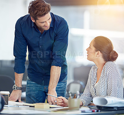 Buy stock photo Shot of two coworkers talking together in an office