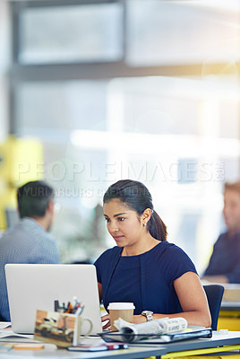 Buy stock photo Shot of a young woman working at her computer in an office