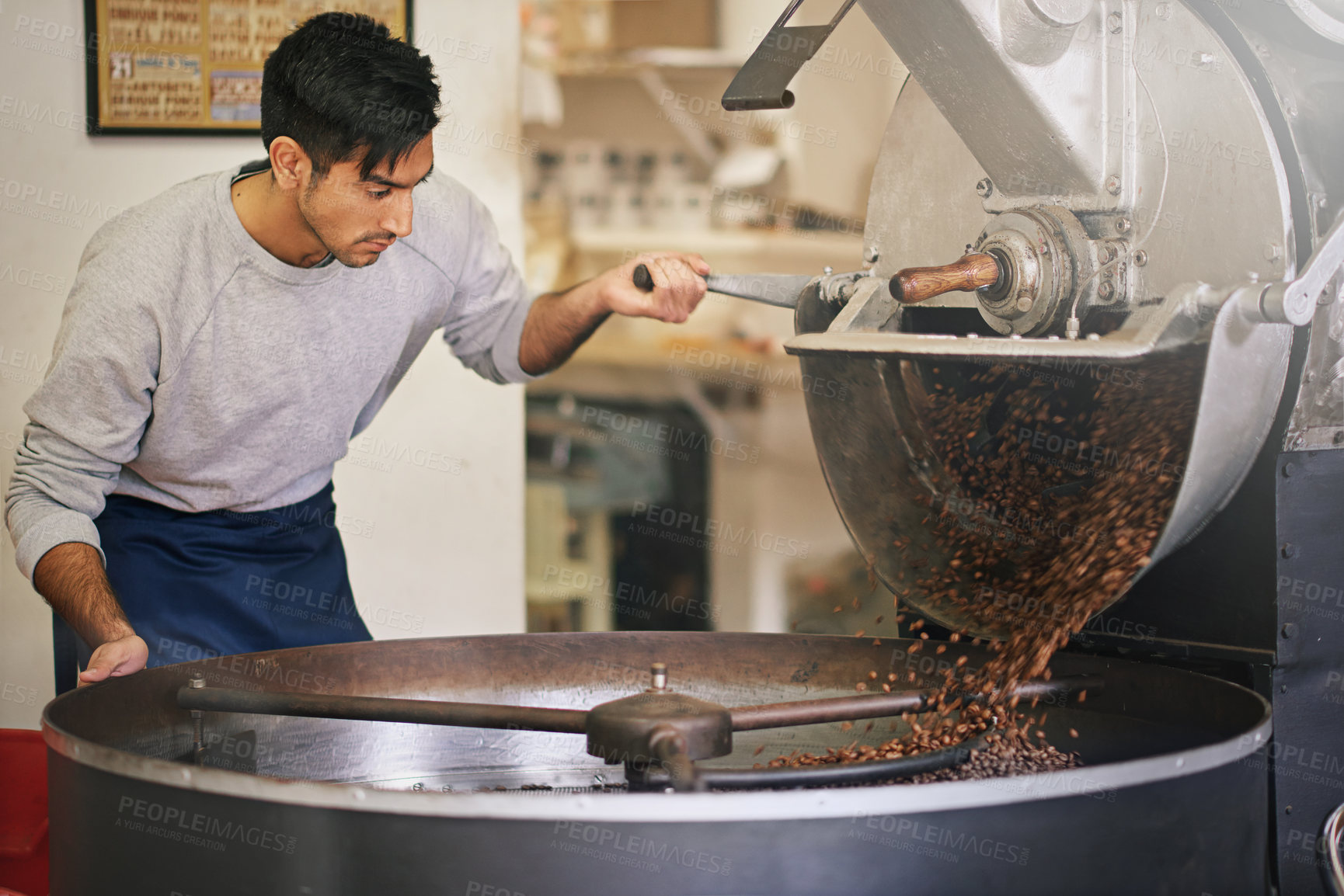 Buy stock photo Coffee shop, small business and man at machine for roasting with blending, production or quality control. Entrepreneur, barista or roaster with beans at cafe, sustainable startup and espresso process