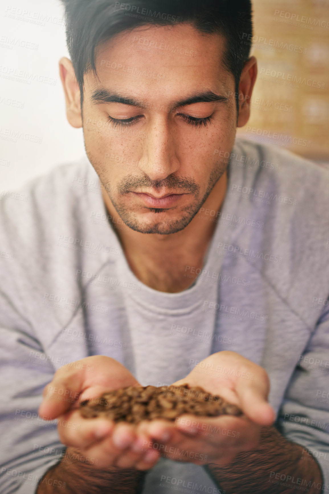 Buy stock photo Man, holding coffee beans and production with smell, thinking and organic grain for export at warehouse. Person, employee and crop for manufacturing, industry and factory for aroma test in Colombia