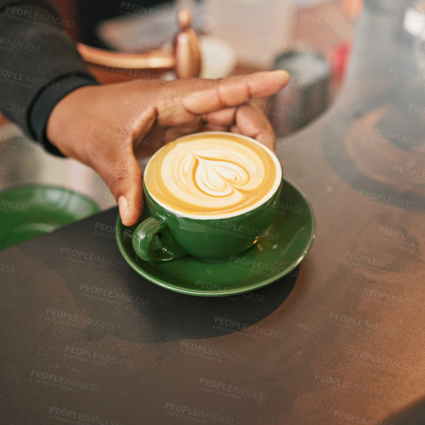 Buy stock photo Hand, coffee cup and latte art for creativity, closeup of cappuccino or caffeine drink on counter with barista. Person with warm beverage, foam and milk with design, hospitality and service at cafe